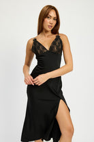 Model wearing a black satin slip midi dress with lace V-neckline and side slit.