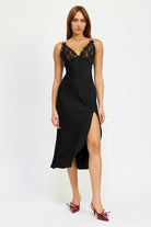 Model wearing a black satin slip midi dress with lace V-neckline and side slit.