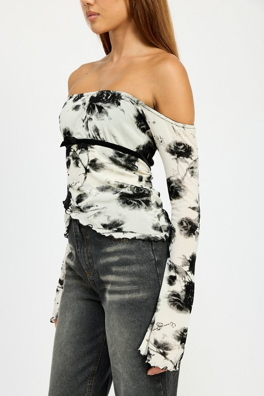 Side view of off-shoulder floral long sleeve top with sheer mesh fabric

