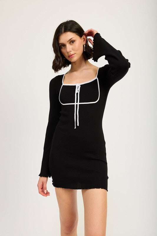 A model wearing a long sleeve black mini dress with a square neckline and a front tie.