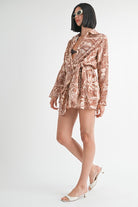 Side view of model showing belted waist and tropical pattern