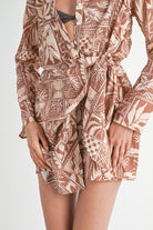 Close-up of belt and tropical print on shirt dress