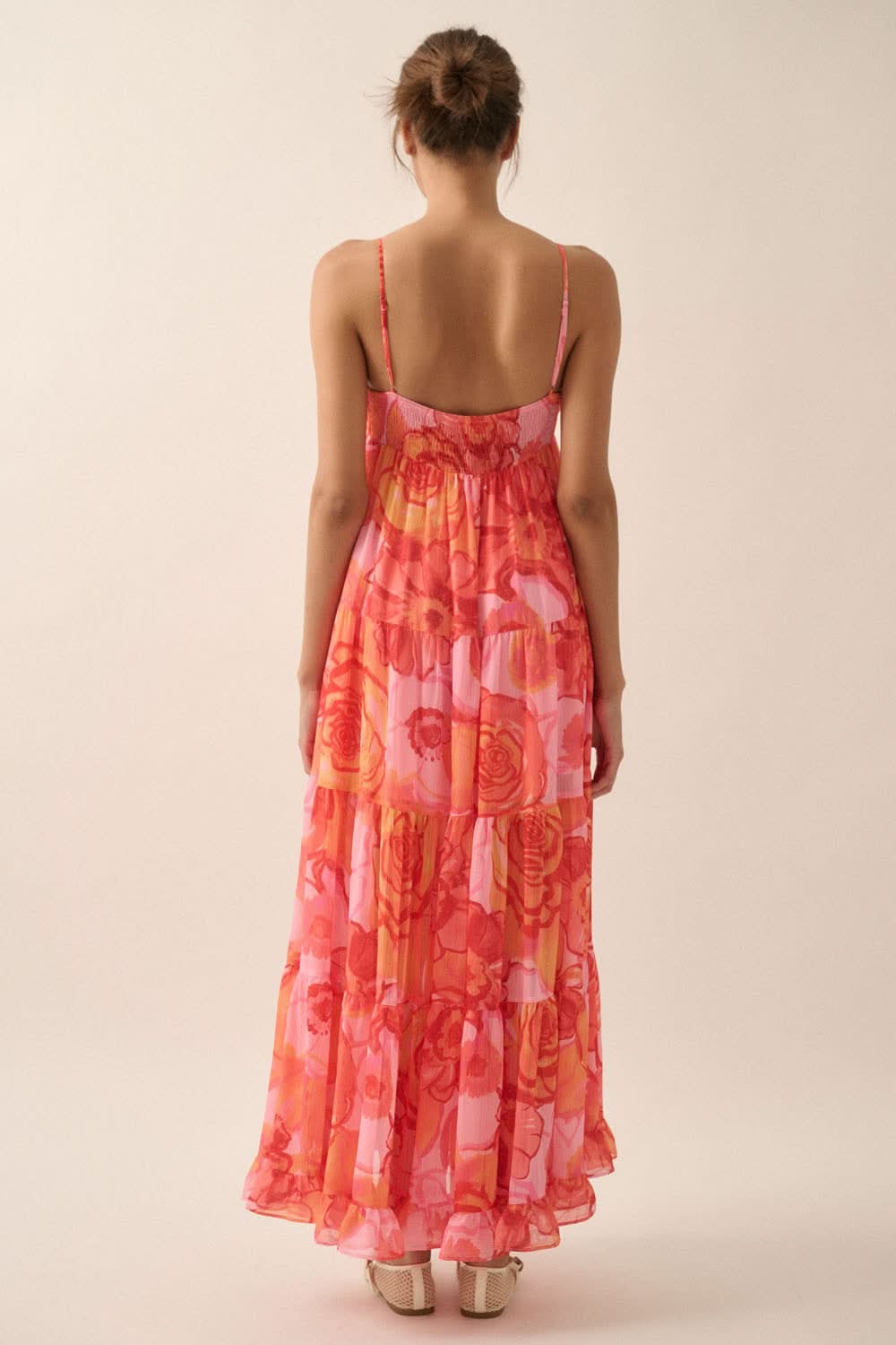 Back view of floral maxi dress with smocked elastic panel and ankle-length hem, showing relaxed fit and low scoop back.