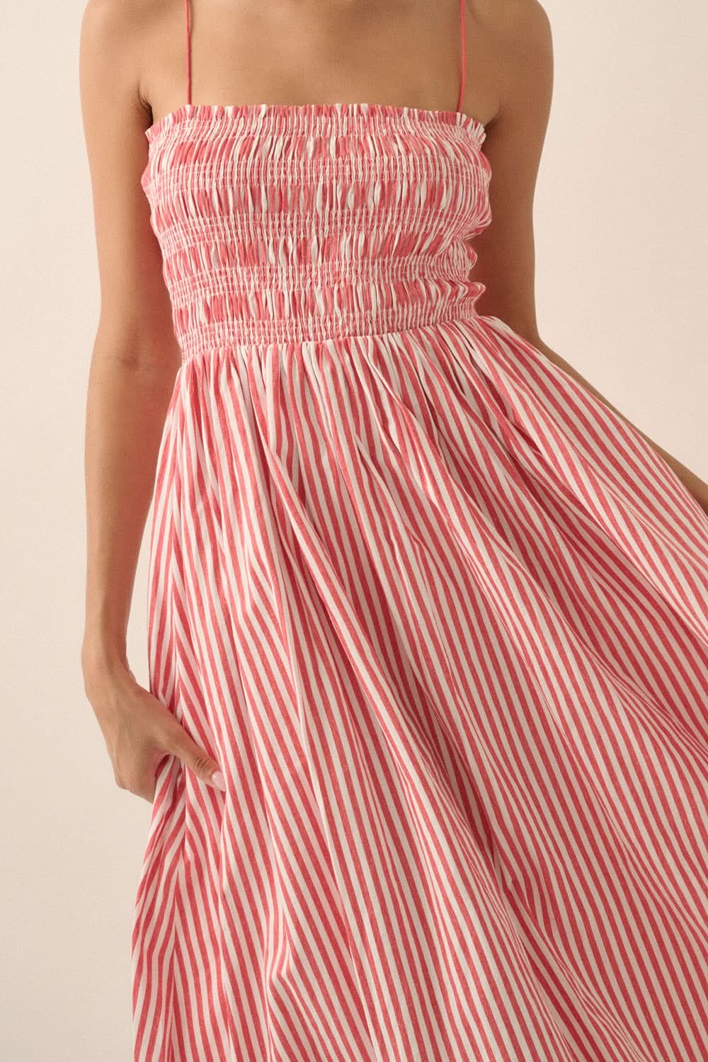 Close-up of smocked bodice and ruffled neckline of red and white striped midi dress