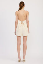 Back view of open-back halter top with tie and shorts