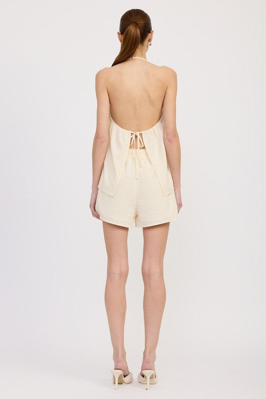 Back view of open-back halter top with tie and shorts