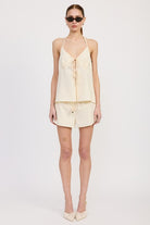 Full-length front view of model wearing ivory halter and shorts