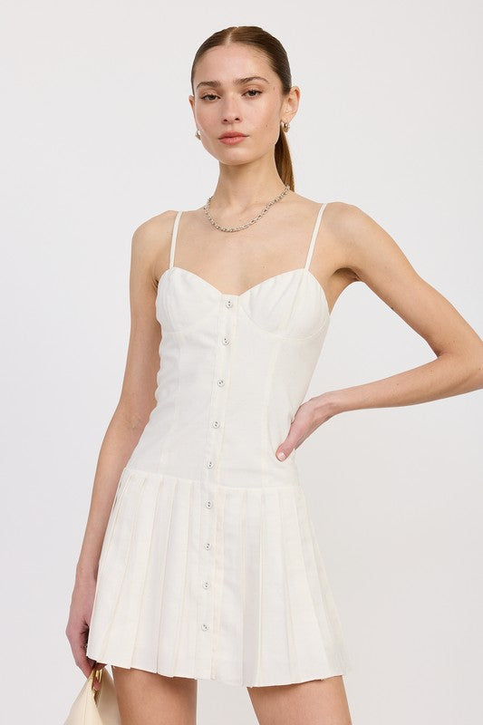 AVAH-Front view of model in ivory pleated mini dress with button-down front and sweetheart neckline