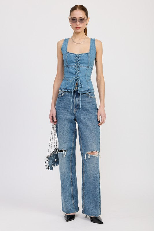 Full outfit: model styled in denim top and wide-leg jeans with ripped knees