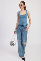 Full outfit: model styled in denim top and wide-leg jeans with ripped knees