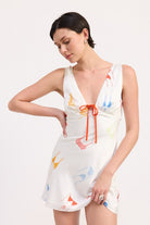 AVAH-Front view of mini dress with bikini print, deep V neckline, and bow tie
