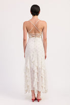 Back view of ivory dress with crisscross tie-back and ruffles