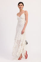 Side angle of ruffle polka dot maxi dress with strappy detail