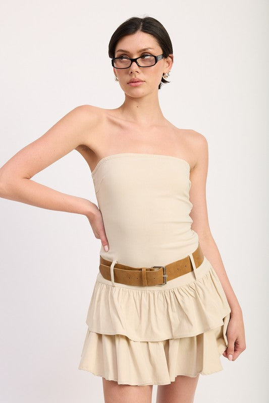 AVAH-Model wearing beige strapless mini dress with tiered ruffle skirt and tan belt, front view