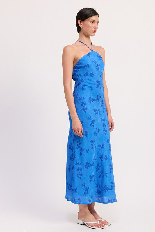 Side view of blue floral halter midi dress with cross strap tie detail