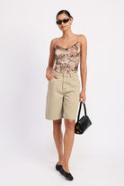 AVAH-Full outfit front view – sage shorts styled with a printed mesh top and black flats