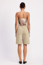 Back view – rear pockets and tailored structure of sage shorts