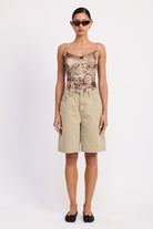 Full front view – high-rise sage shorts styled casually with flats