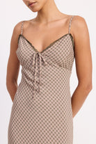 Close-up of lace-trim tie detail at bust of printed maxi dress
