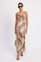 Model wearing animal print slip dress with cowl neck.