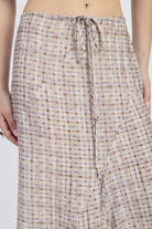 Close-up of drawstring waist and plaid pattern on maxi skirt