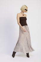 Model wearing maxi plaid skirt in motion, angled pose