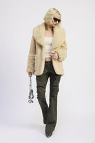 Full-length outfit featuring faux shearling teddy coat styled with cargo pantS-AVAH