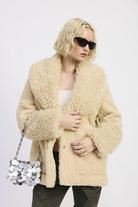 Woman posing in beige taupe teddy coat and dark sunglasses-AVAH