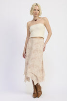 Model wearing Wild Rose layered midi skirt with soft leopard and rose print, paired with knit tube top and tall brown boots