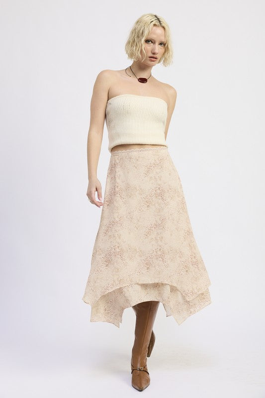 Model walking in Wild Rose layered midi skirt styled with knit top and boots
