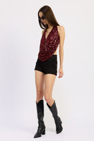 Side view of red sequin draped halter top showing open sides and deep front drape.