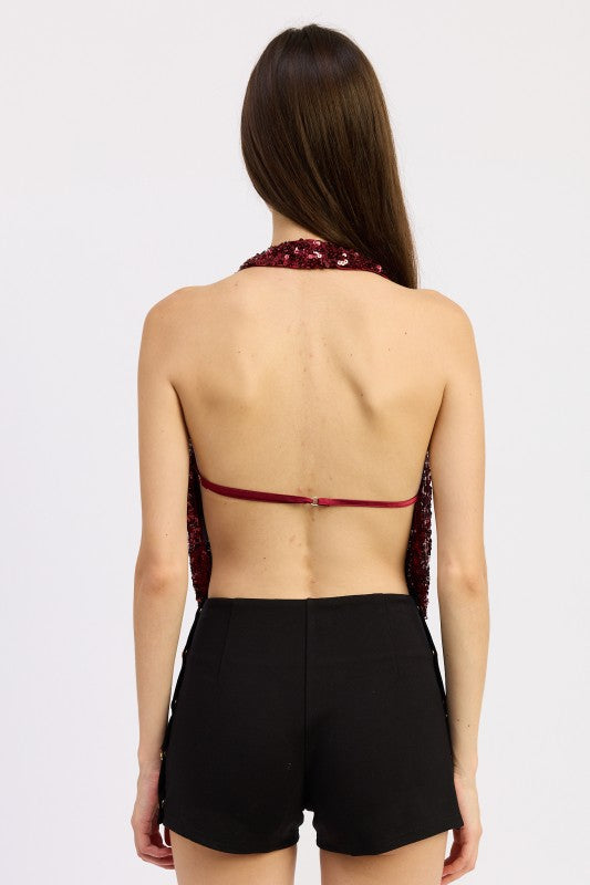Back view of the red sequin halter top showing open back with thin strap detail.