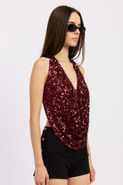 Side view of red sequin draped halter top showing open sides and deep front drape.