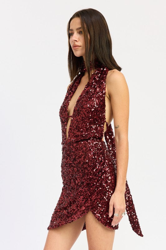 Side view of wine sequin deep-plunge mini dress with asymmetric mini hem.
