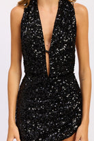 Close-up of black sequin deep-V neckline mini dress
