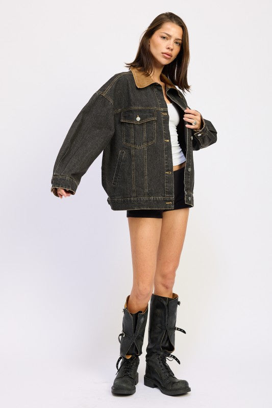 Model wearing oversized black denim jacket- full side angle.