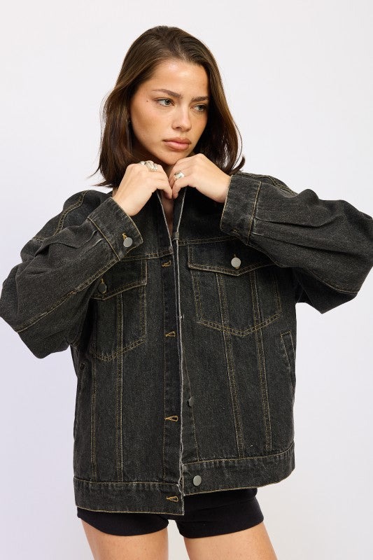 Model wearing an oversized black denim jacket with a tan corduroy collar