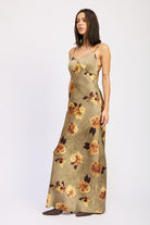 Side view of AVAH slip maxi dress in olive with golden floral print.