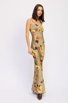 Side view of AVAH slip maxi dress in olive with golden floral print.