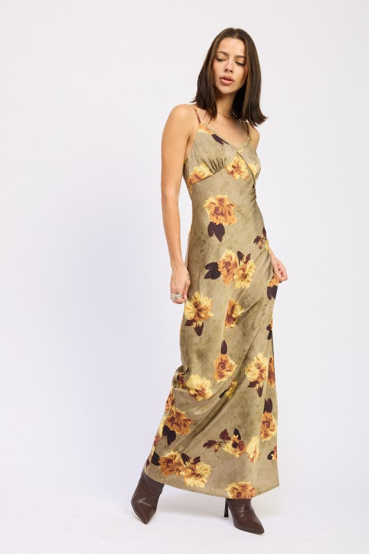 AVAH olive floral maxi dress styled with pointed boots, angled pose.