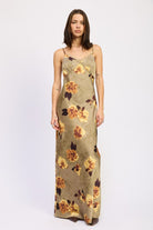 Model in AVAH olive floral maxi dress with spaghetti straps and fitted bust, front view.