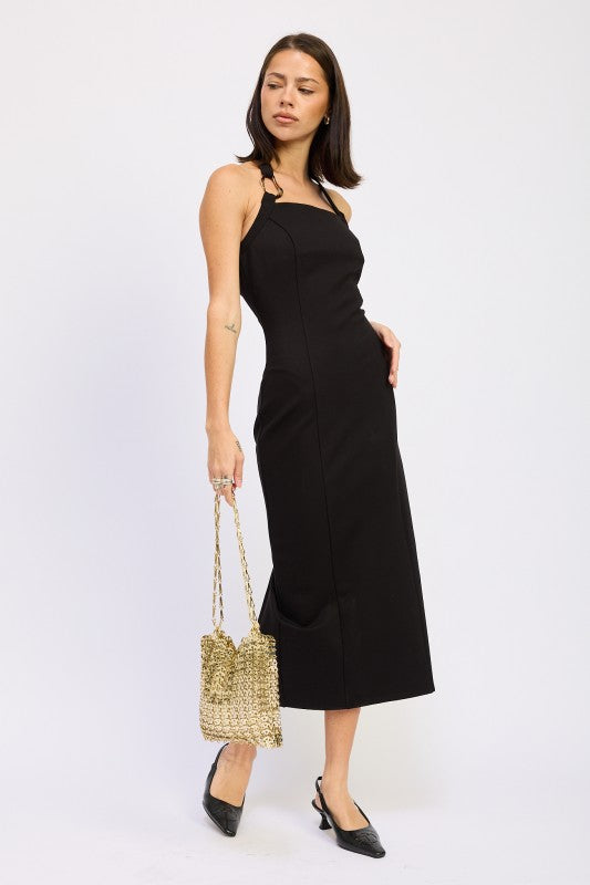 Black halter neck midi dress side angle view, styled with gold bag and black kitten heels 
