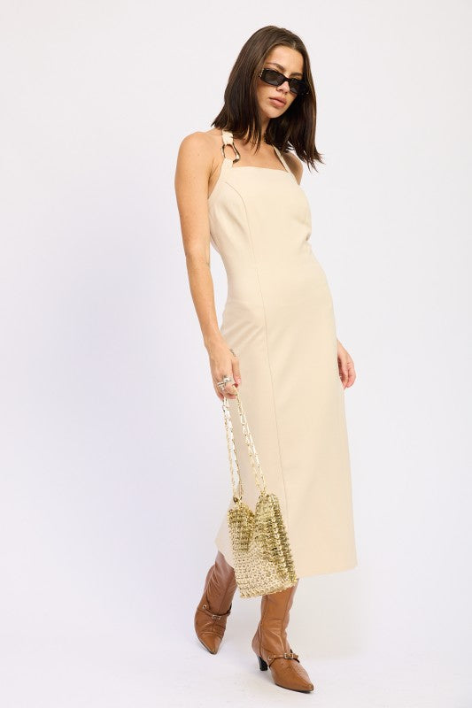 AVAH Taupe  halter neck midi dress with back slit, styled with brown boots and gold bag-angled view