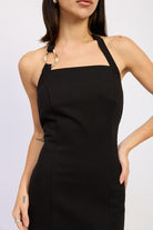 Black fitted midi dress with ring strap detail close-up