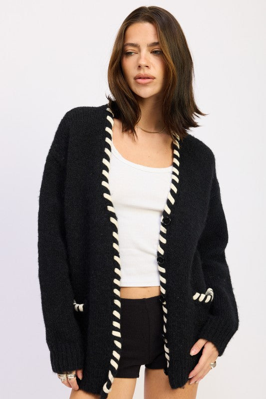 Front view of model wearing contrast leather trim black cardigan sweater over white tank-AVAH