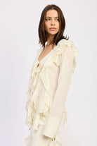 Side view of cream blouse showing layered ruffle trim