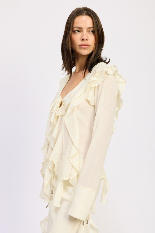 Side view of cream blouse showing layered ruffle trim