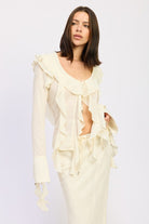 Feminine cream blouse with cascading ruffles, profile view