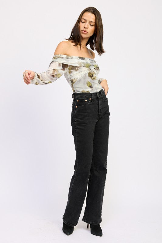 Full body view of AVAH floral mesh ruched bodysuit styled off-shoulder with straight-leg black jeans.