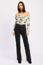 Full body view of AVAH floral mesh ruched bodysuit styled off-shoulder with straight-leg black jeans.